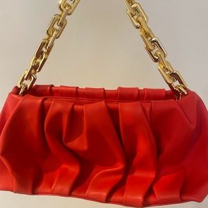 Red faux leather handbag